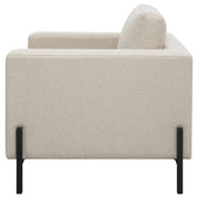 Sillón Tilly tapizado con brazos articulados en color avena