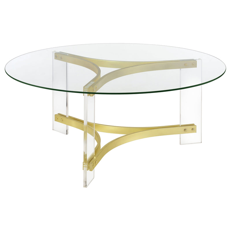 Mesa de centro Janessa redonda con tapa de vidrio y patas acrílicas, latón mate