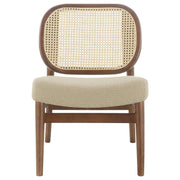 Sillón Rayo con respaldo de caña de ratán y asiento acolchado, color negro