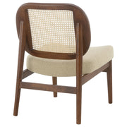 Sillón Rayo con respaldo de caña de ratán y asiento acolchado, color negro