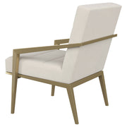 Sillón Kirra con brazos de metal tapizados en color crema