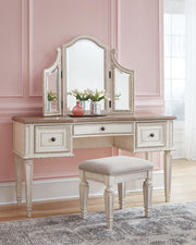 Realyn King Panel Bed, Dresser, Mirror, Chest, Vanity and Nightstand