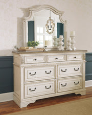 Realyn California King Upholstered Panel Bed with Mirrored Dresser and Chest