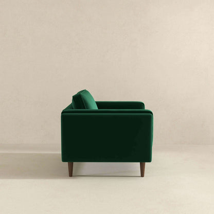 Sillón de terciopelo verde oscuro ámbar