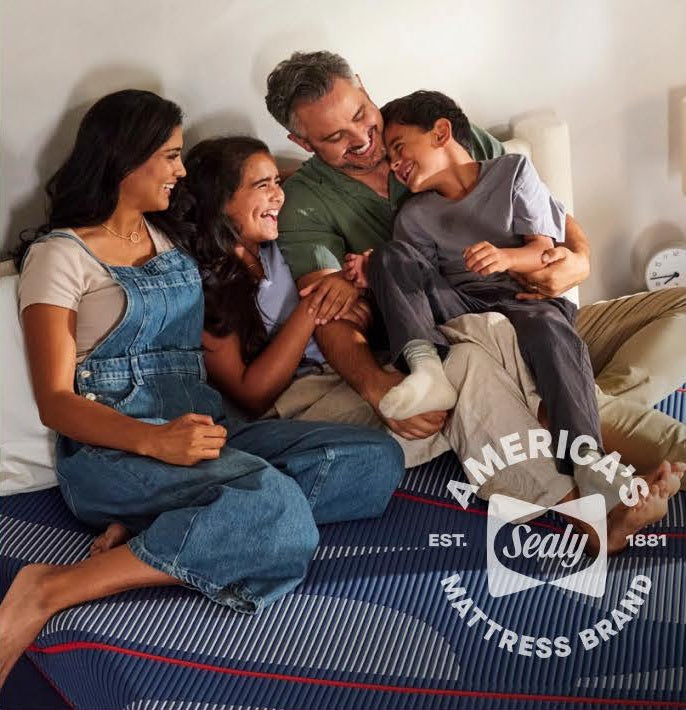 Family resting together on a Sealy mattress