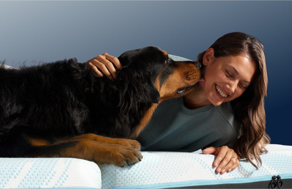 Woman with her dog on a Tempur-Pedic mattress